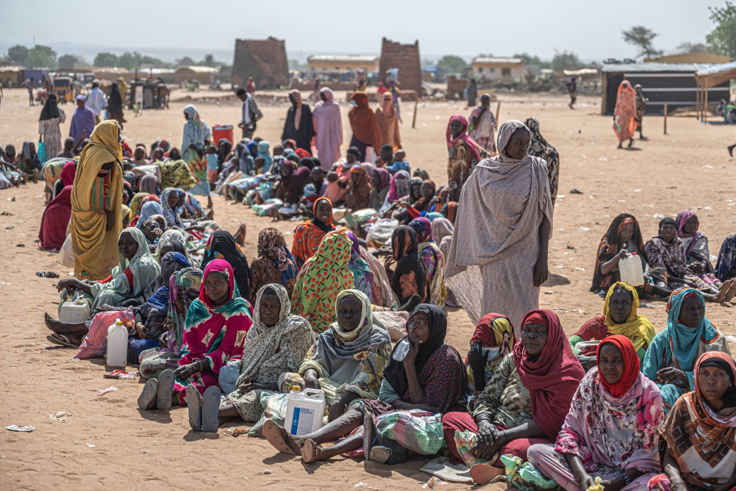250627 -- ADRE, June 27, 2025 -- Sudanese refugees wait for food distribution at a register station in Adre, Chad, on June 25, 2025. According to the statistic figures released by the UN earlier in June, more than 844,000 Sudanese refugees have fled to Chad after war broke out in Sudan in April 2023.  SpotNewsCHAD-ADRE-SUDAN-REFUGEE INFLUX WangxGuansen PUBLICATIONxNOTxINxCHN